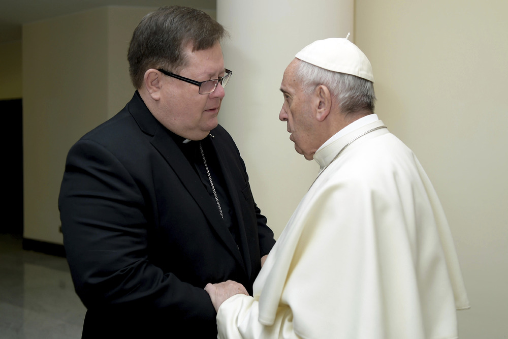Pope Francis, Cardinal LaCroix, sex abuse investigation Pope Francis faces Cardinal La Croix, with hand on arm, in conversation.