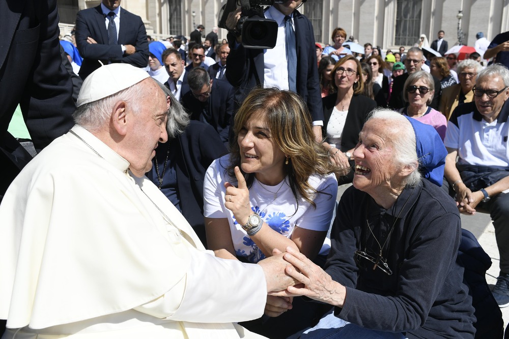 Pope Francis and Sister Genevieve Pope Francis, seated, shakes hands Sister Genevieve, also seated.