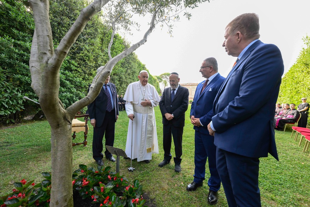 Pope Francis begs God for peace in Holy Land Pope and dignitaries stand around olive tree in garden while speaking