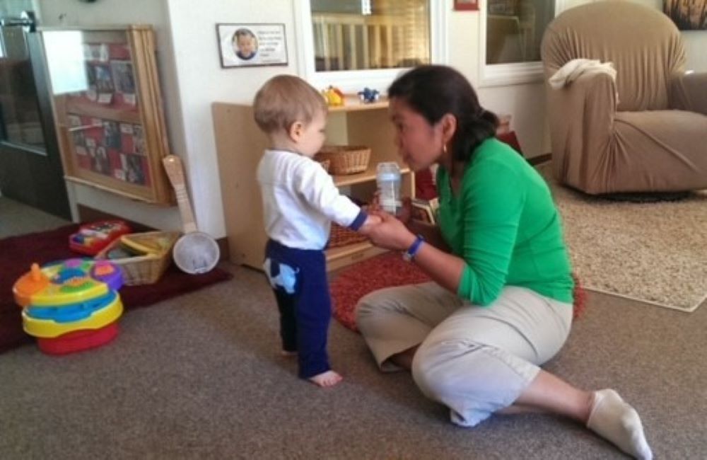 Sr. Nodelyn Abayan interacts wih a baby at a campus child care center in San Francisco in February 2014. She said she's grateful for the trust and sacred nature of working with babies and families. (Courtesy of Nodelyn Abayan)