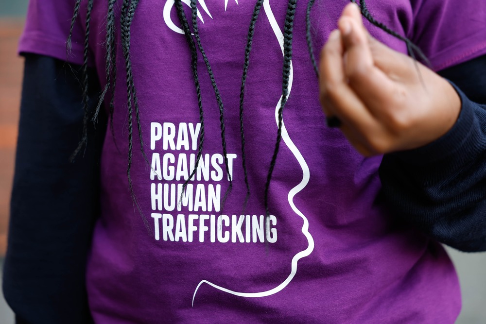 Mary Mugo, Nairobi, Kenya, youth ambassador for Talitha Kum, 2024. Graphic on t-shirt shown, worn by woman with long braids.