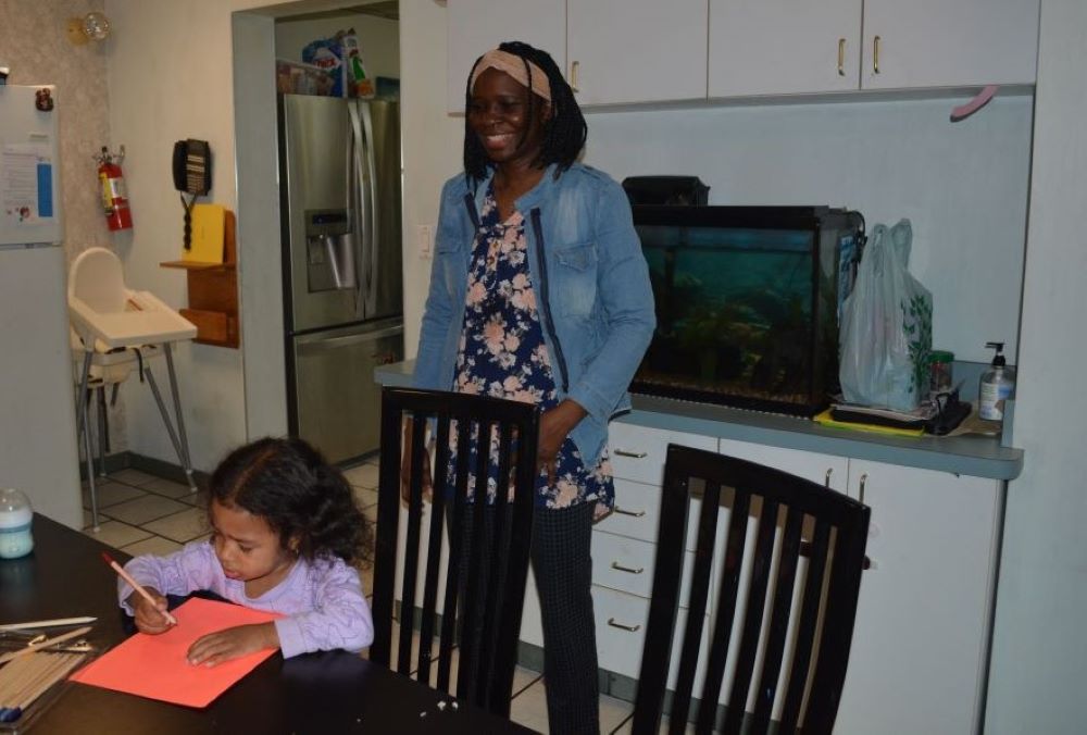 Franciscana Clarisa Sr. Stella Akello, intake officer at Bethany House of Hospitality for 18- to 25-year-old refugee women, spends time with residents' children after school is out May 7. Franciscana Clarisa Sr. Stella Akello, intake officer at Bethany House of Hospitality for 18- to 25-year-old refugee women, spends time with residents' children after school is out May 7.