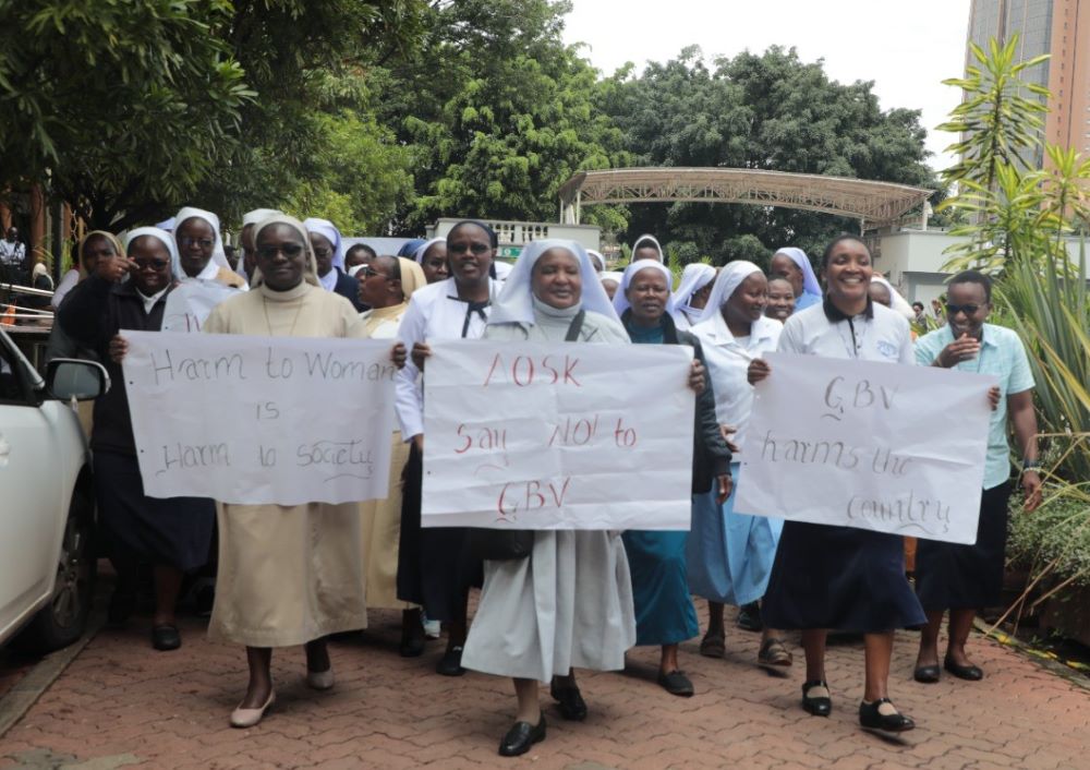 Members of the Association of Sisterhoods in Kenya carry signs to raise awareness about gender-based violence. Members of the Association of Sisterhoods in Kenya carry signs to raise awareness about gender-based violence.