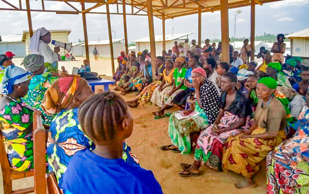 Servant of Jesus Sr. Angèle Gapio addresses refugees on the border of Uganda and the Democratic Republic of Congo. (Courtesy of Dieu Donne, Pax Christi International)
