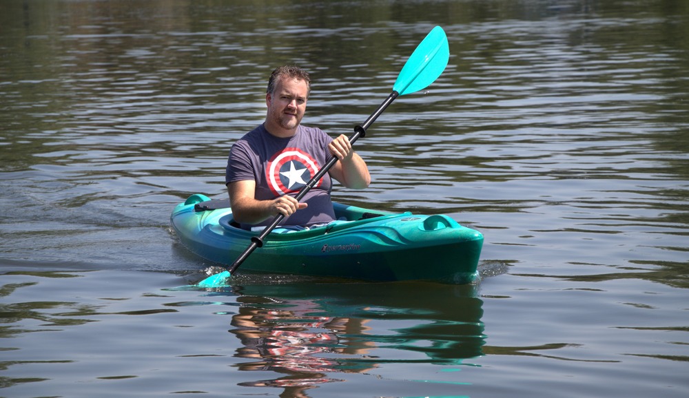 Scott Kieffer, a parishioner and staff member of St. Joseph the Worker Catholic Community in Maple Grove, Minn., paddles out on Medicine Lake in Plymouth to pray the rosary. Man in kayak on water.