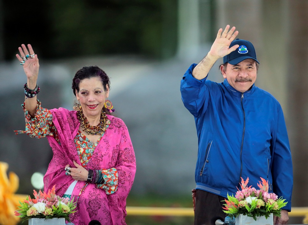 icaraguan President Daniel Ortega and his wife, Vice President Rosario Murillo; Managua March 21, 2019. The Presidential couple stand waving and smiling in open air.