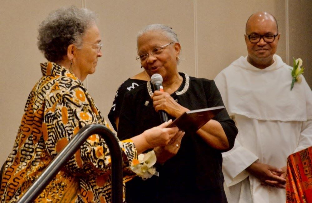 Sr. Eva Marie Lumas, a Sister of Social Service, (left) accepts the National Black Sisters Conference's Harriet Tubman Award from National Black Sisters' Conference President Sr. Addie Lorraine Walker July 29, 2024, in Louisville. Looking on is Fr. Jeffery Ott. (GSR photo/Dan Stockman) Sr. Eva Marie Lumas, a Sister of Social Service, (left) accepts the National Black Sisters Conference's Harriet Tubman Award from National Black Sisters' Conference President Sr. Addie Lorraine Walker July 29, 2024, in Louisville. Looking on is Fr. Jeffery Ott. (GSR photo/Dan Stockman)