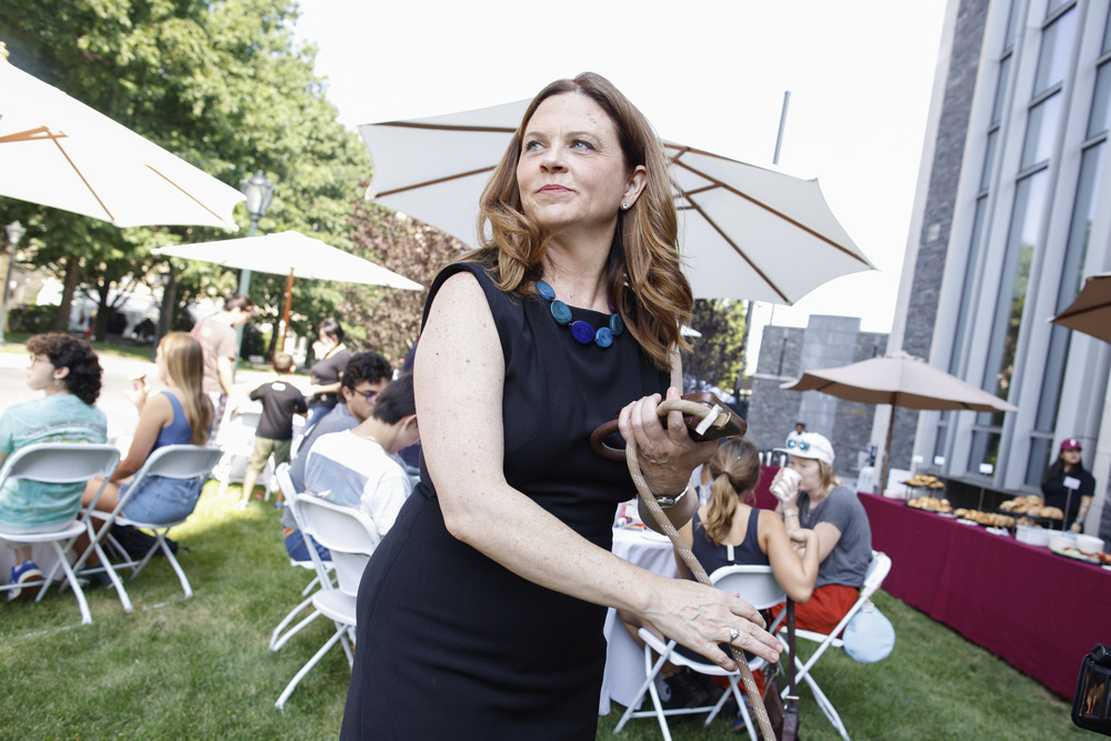 Tania Tetlow, President of Fordham University, Bronx, New York, Aug. 25, 2024. Tetlow holds dog leash and turns to face someone.