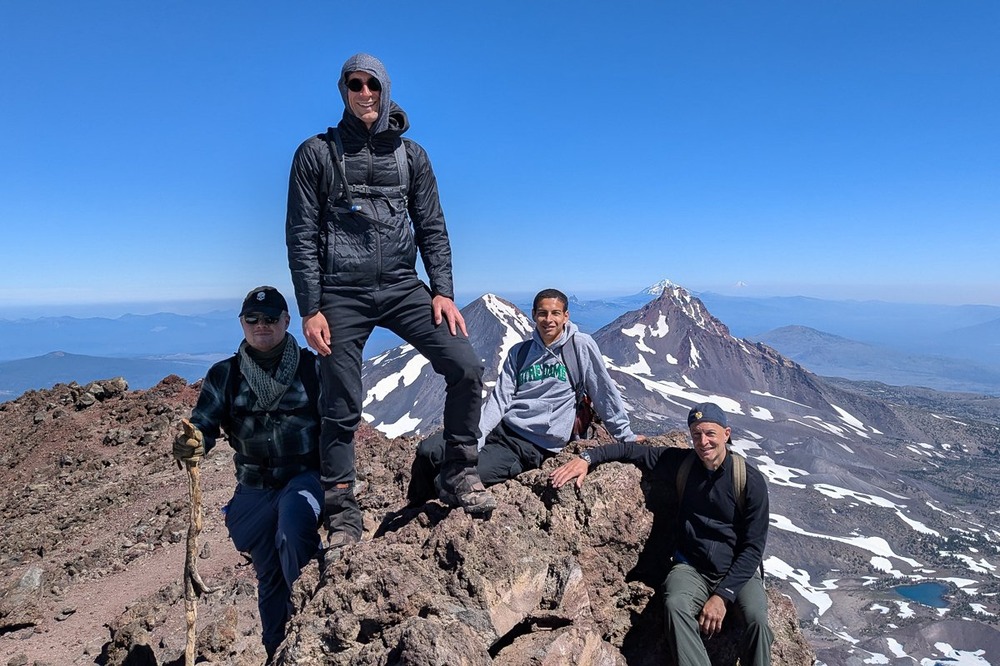 Benedictine monks of Mount Angel Abby Bros. Gabriel Brands, Ambrose Stewart, Brandon Contreras, and Fr. Michael Shrum, South Sister Mountain, Oregon, July 18, 2024. The four stand or sit, in the background is enormous vista.
