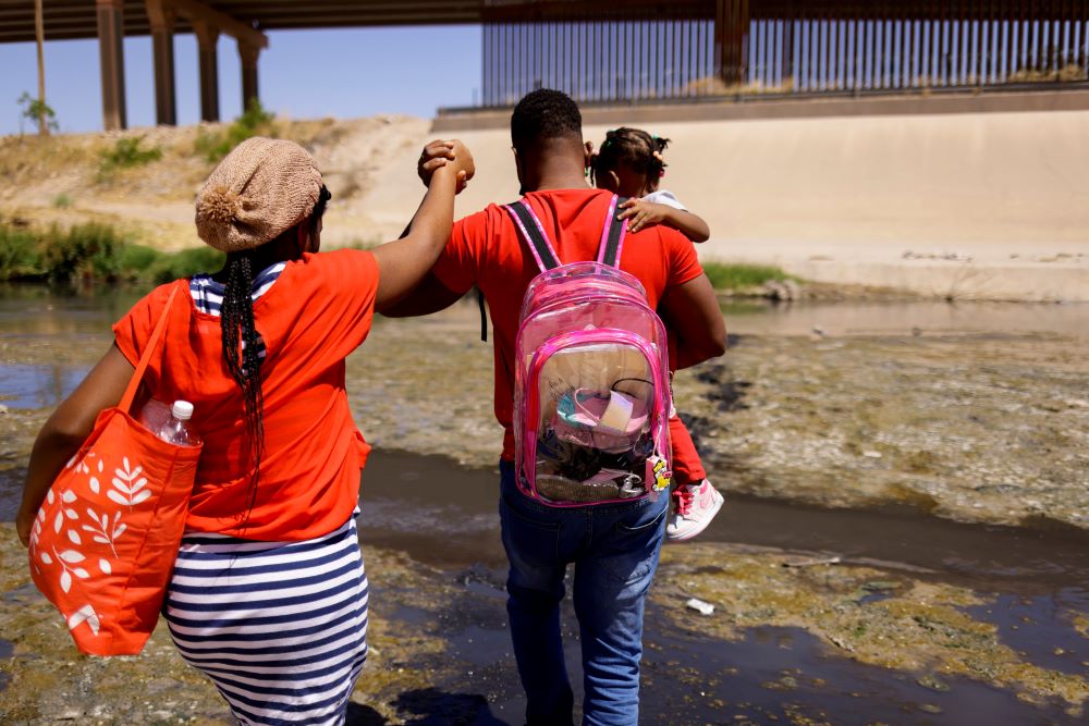 An asylum-seeking migrant family from Haiti cross the Rio Bravo. An asylum-seeking migrant family from Haiti cross the Rio Bravo.