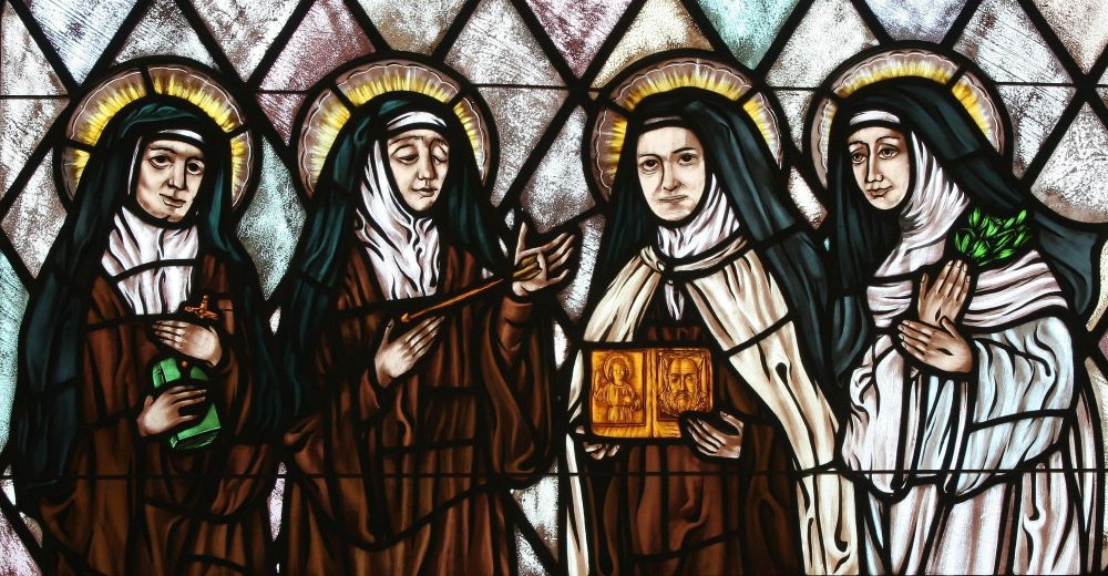 Stained glass depicts Sts. Teresa Benedicta of the Cross, Theresa of Avila, Thérèse of Lisieux and Catherine of Siena. Stained glass depicts Sts. Teresa Benedicta of the Cross, Theresa of Avila, Thérèse of Lisieux and Catherine of Siena.