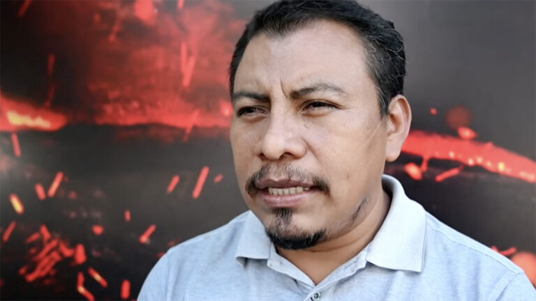 Juan Antonio Lopez. Lopez shown shoulders-up against red and black background.