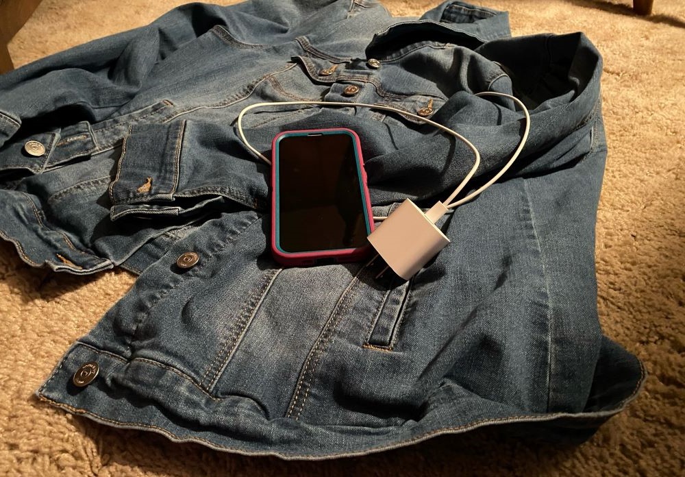 A denim jacket and a cellphone A denim jacket and a cellphone