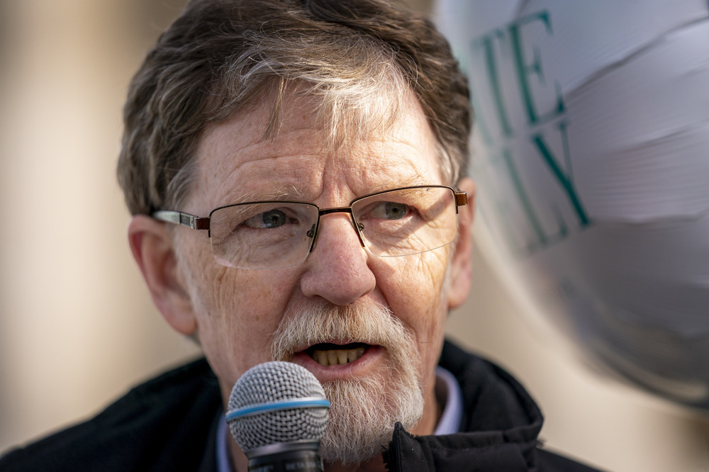 Jack Phillips, Colorado baker, outside of Supreme Court building, Washington D.C, Dec. 5, 2022. Close-up of Phillips speaking into microphone.