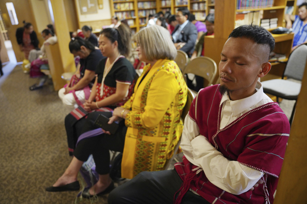 Karen-language service, Indian Lake Baptist Church, Worthington, Minn., Oct. 20, 2024. People seated in rows, eyes closed.