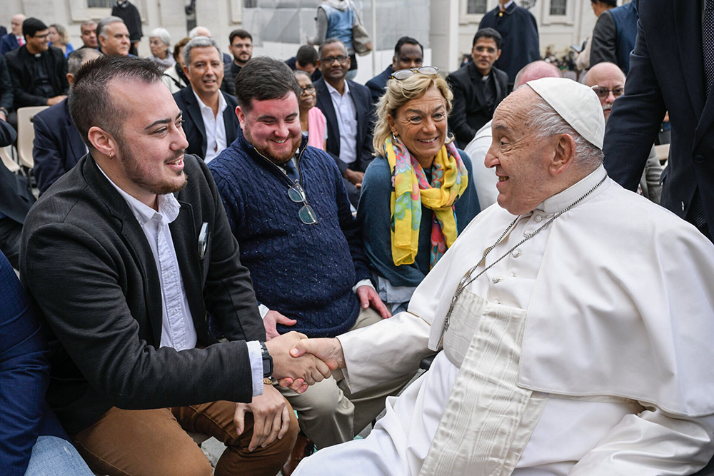 On Oct. 23, 2024, Maxwell Kuzma meets Pope Francis after a general audience as part of a group of transgender Catholic men gathered through Outreach, a ministry to LGBTQ Catholics. (Courtesy of Outreach)
