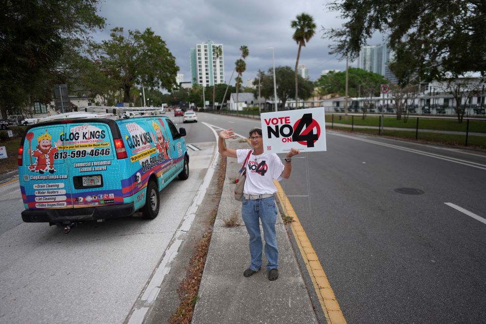 Sonja Kahkonen, an anti-abortion Catholic, holds a sign urging voters to reject Amendment 4, which would have enshrined abortion rights in Florida. Sonja Kahkonen, an anti-abortion Catholic, holds a sign urging voters to reject Amendment 4, which would have enshrined abortion rights in Florida.