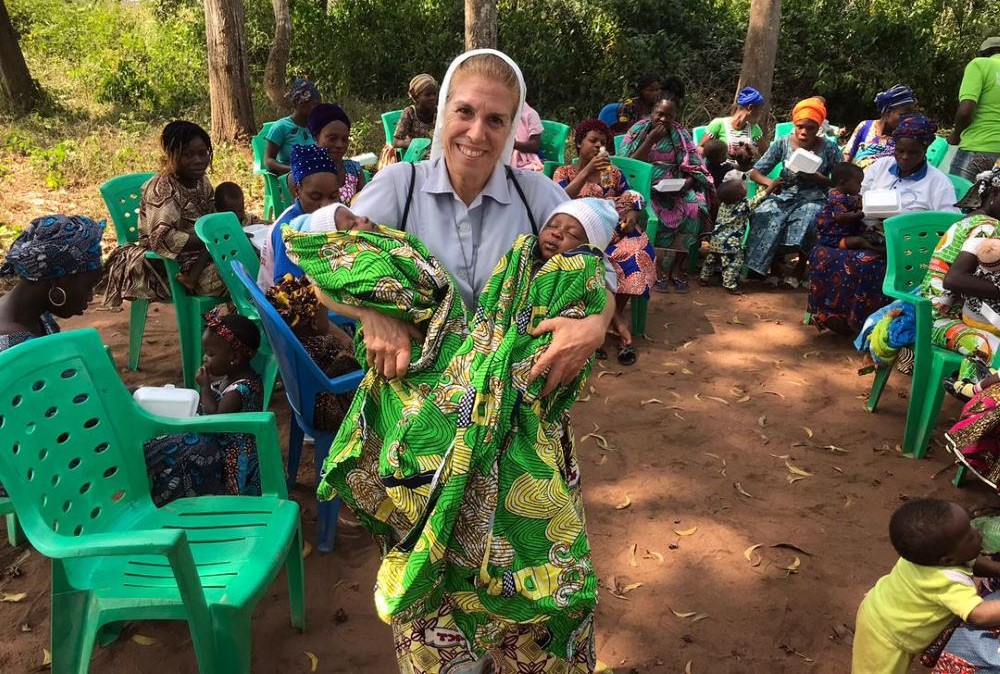Sr. Monique Bourget holds healthy twins in Benin. Sr. Monique Bourget holds healthy twins in Benin.