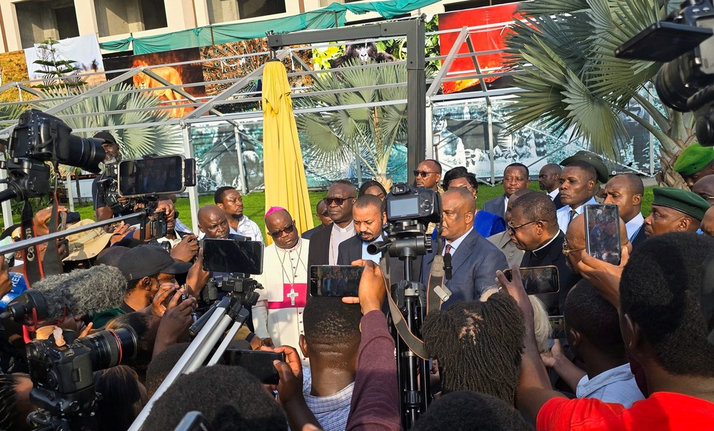 Bishop Willy Ngumbi Ngengele and other Congolese Catholic leaders, press conference, Goma, Feb. 12, 2025. Bishop and priests framed by large swarm of press.