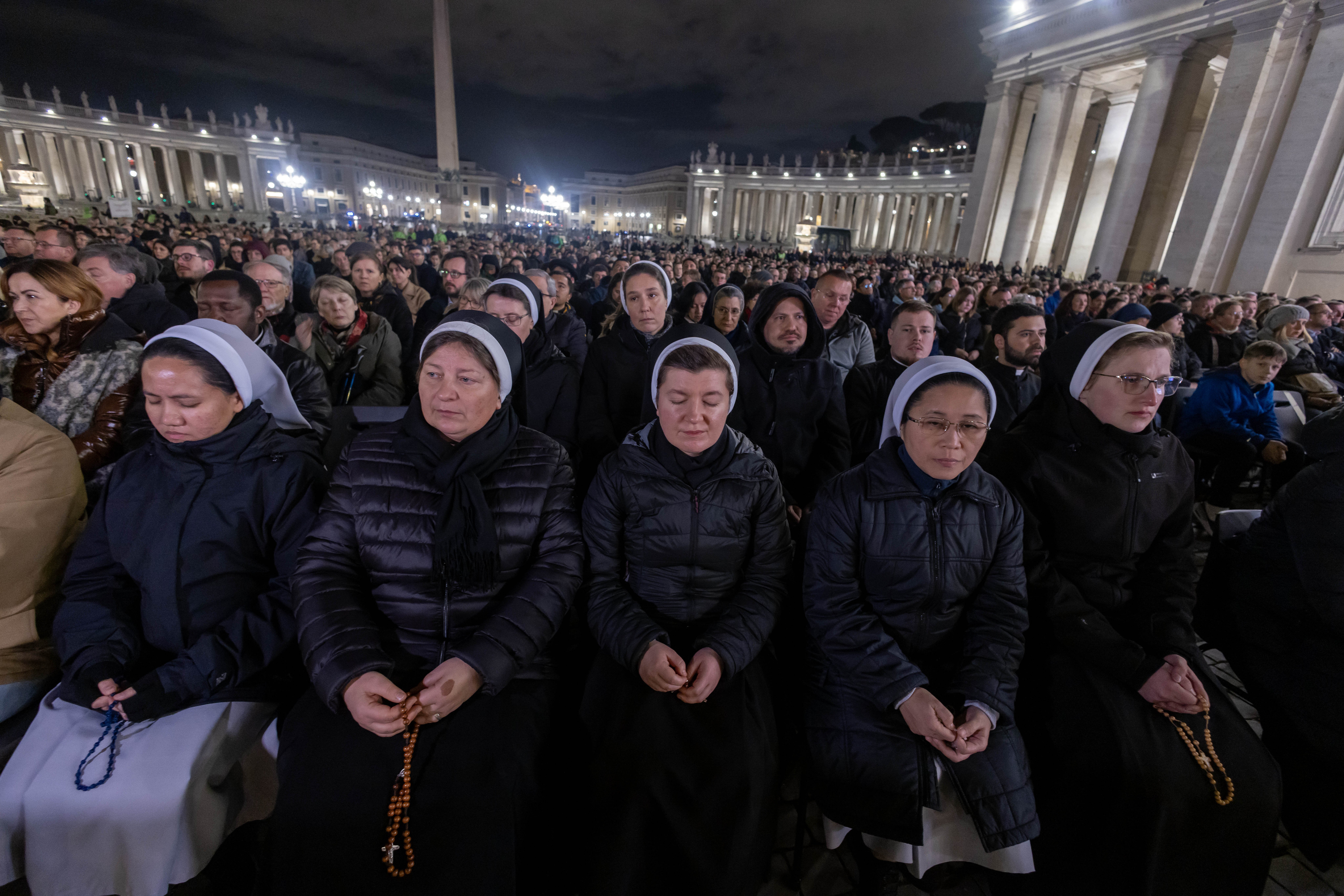 People join Cardinal Víctor Manuel Fernández, prefect of the Dicastery for the Doctrine of the Faith, for the recitation of the rosary for Pope Francis in St. Peter’s Square at the Vatican 