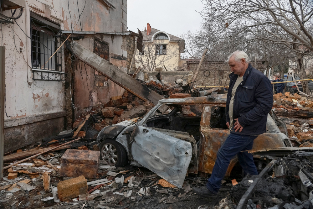 Rubble in Ukraine A sad-looking resident is seen walking through rubble at a site of an apartment building in Odesa, Ukraine, which was hit by a Russian drone strike amid Russia's attack on Ukraine.