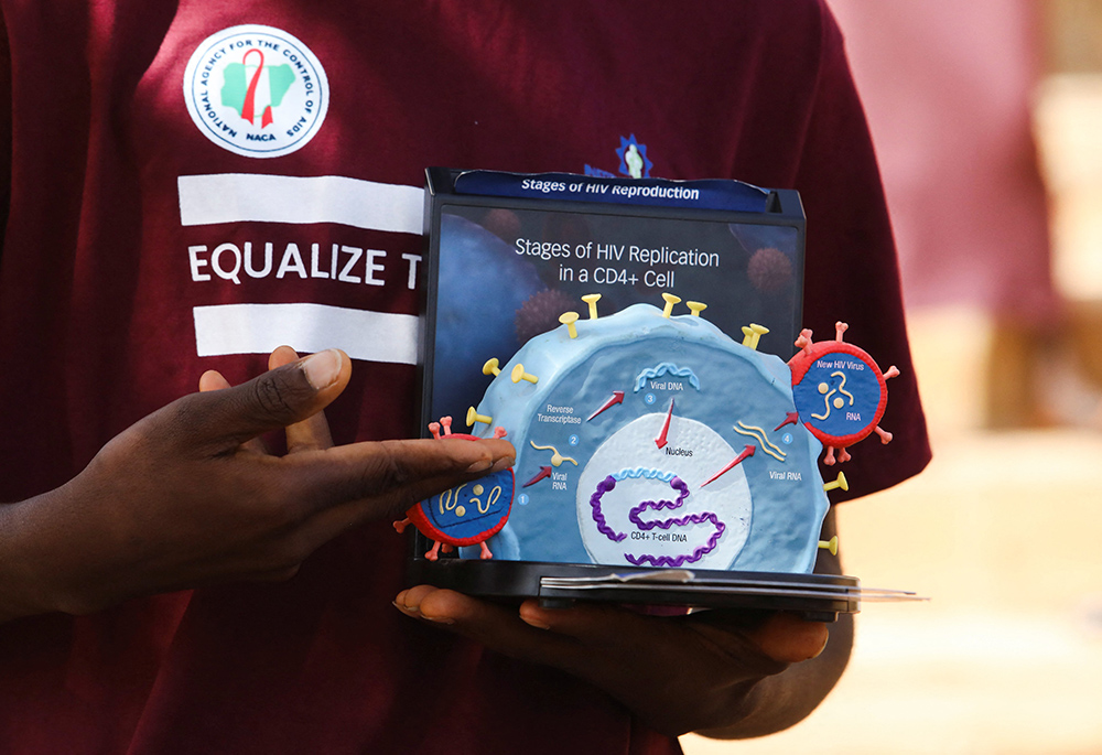 Peer educator Abraham Nnam uses a model of the HIV virus to illustrate a lesson on AIDS to youths at a primary health center in Kobi suburb, Abuja, Nigeria, Nov. 30, 2022. The future of PEPFAR, the U.S. government's global effort to combat HIV/AIDS, is unclear amid a pause on foreign assistance triggered by a Jan. 20, 2025, executive order from President Donald Trump. (OSV News/Reuters/Afolabi Sotunde)