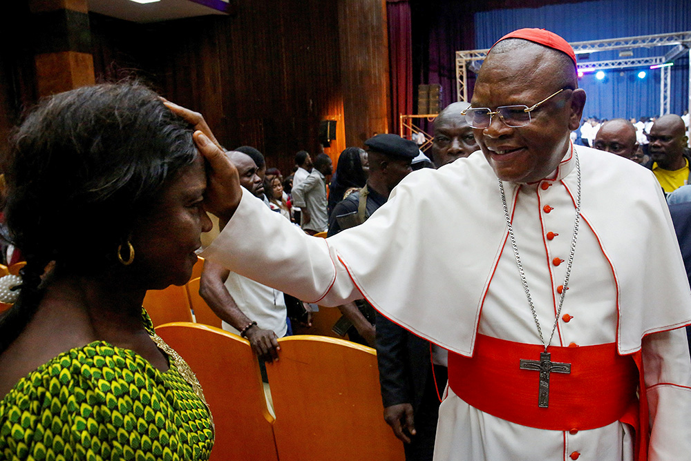 Cardinal Fridolin Ambongo Besungu blesses a woman during a gospel music festival in Kinshasa, Democratic Republic of Congo, Jan. 29, 2023. (OSV News/Reuters/Luc Gnago)