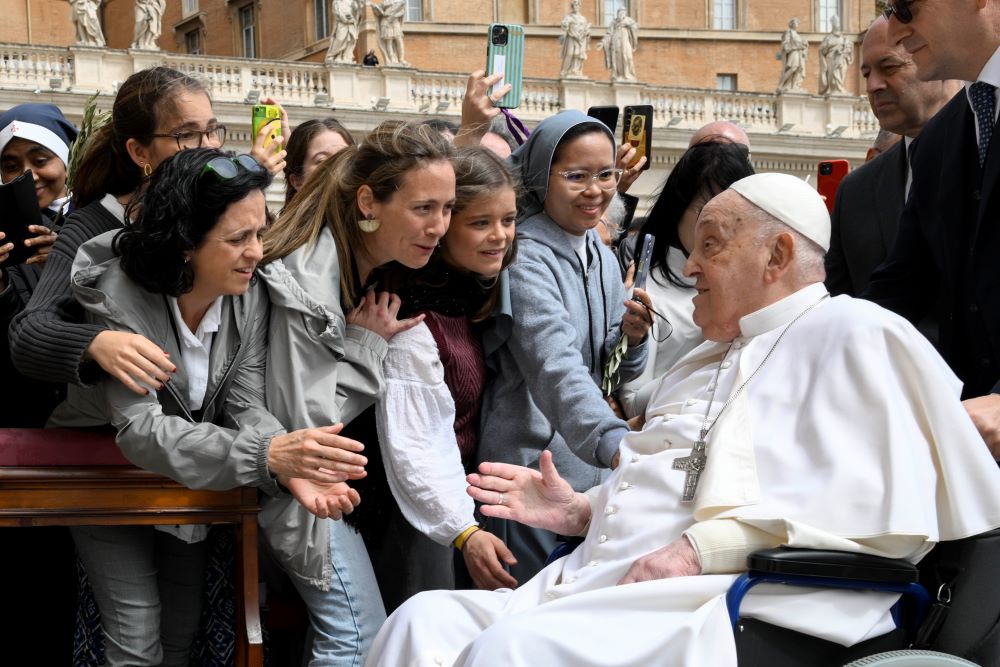 Pope Francis greets people.