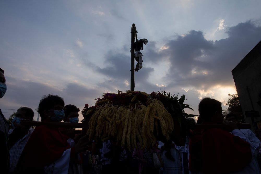 Catholics take part in a reenactment of the Stations of the Cross,