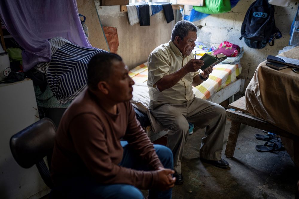 Nicaraguan exile Francisco Alvicio, right, a deacon of Nicaragua's Moravian Church, prays in his rented room alongside fellow exile and Miskito leader Salomon Martinez Ocampo in San Jose, Costa Rica, Sept. 22. (AP/Carlos Herrera)