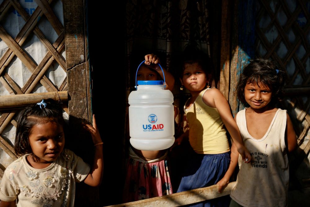 Children with jar labeled "USAID"