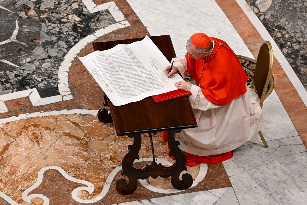 Parolin signs scroll.
