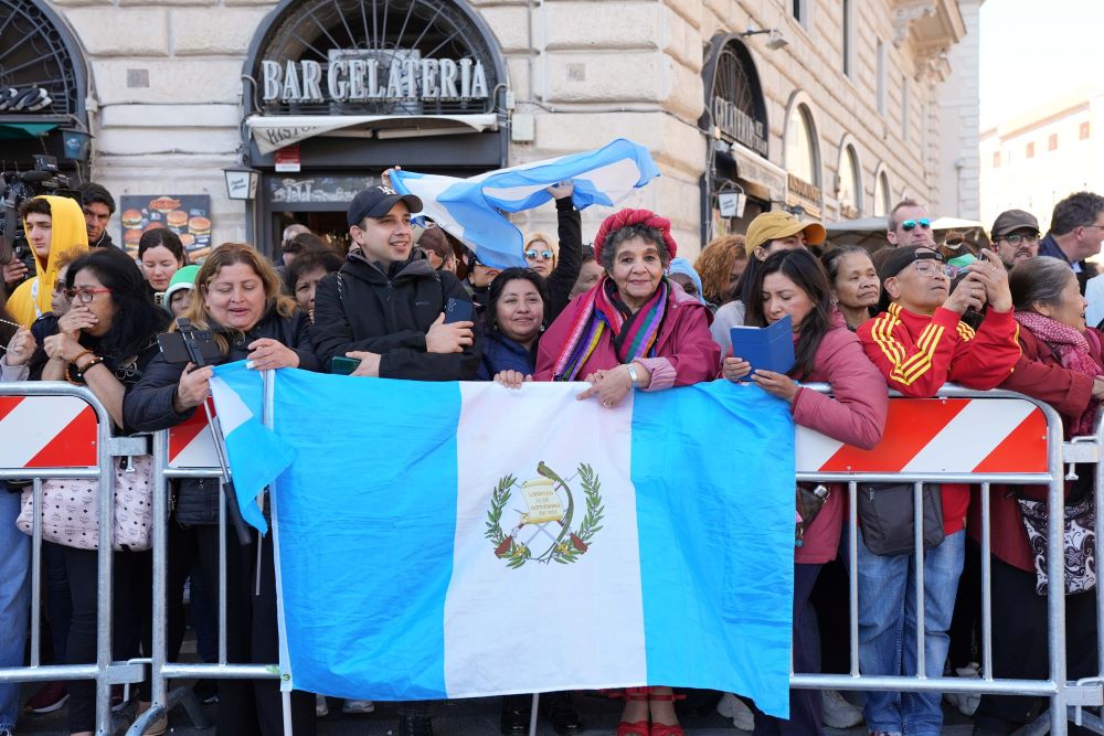 People stand behind the flag of Argentina outside the Basilica of Santa Maria Maggiore, Pope Francis' final resting place. (CNS/Lola Gomez)