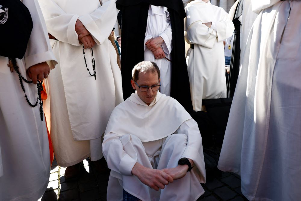A member of the clergy prays during the funeral Mass. (OSV News/Reuters/Matteo Minnella)