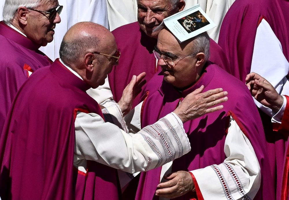 Prelates share the sign of peace during the funeral Mass. (OSV News/Reuters/Dylan Martinez)