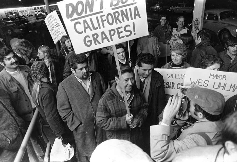 United Farm Workers President Cesar Chavez, carrying a sign calling for a boycott of California table grapes, leads about 400 people picketing a Safeway supermarket in Seattle, Washington, on Dec. 19, 1969. (AP photo/Barry Sweet)