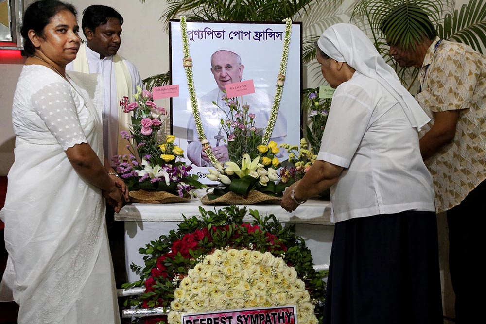 The Sisters of the Holy Cross lay wreaths at the portrait of Pope Francis on behalf of the community on April 27 in Dhaka, Bangladesh. (Stephan Uttom Rozario)