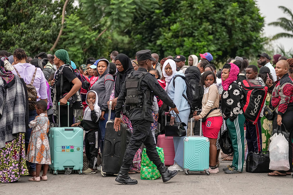 Rwanda security officials check people crossing from Congo in Gisenyi, Rwanda, Jan. 29, 2025, following M23 rebels' advances into eastern Congo's capital Goma. (AP/Brian Inganga)