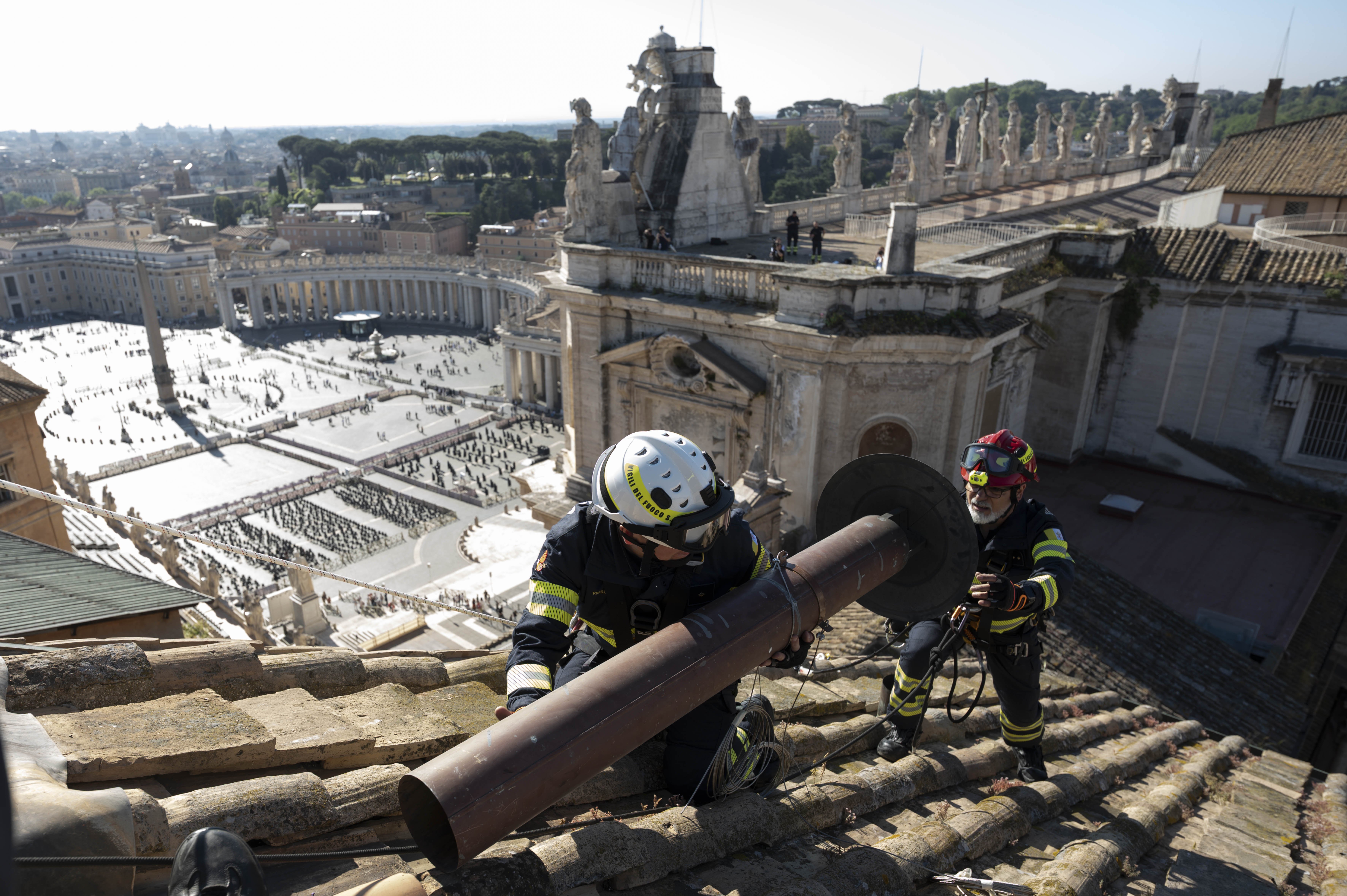 Vatican firefighters install the chimney on the roof of the Sistine Chapel at the Vatican May 2, 2025. Connected to a stove in the chapel where the ballots will be burned during the conclave to elect a new pope, the chimney will signal to the world whether a new pope has been elected. (CNS photo/Vatican Media)