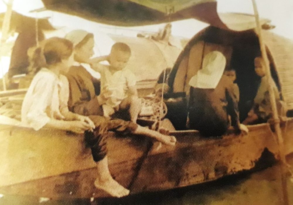 Two Daughters of Our Lady of the Visitation visit people living on a boat in a river in Hue in 1970. (Courtesy photo) Two Daughters of Our Lady of the Visitation visit people living on a boat in a river in Hue in 1970. (Courtesy photo)