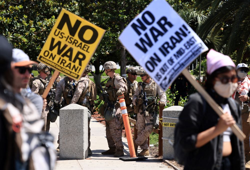 U.S. Marines stand guard as demonstrators protest against the United States joining with Israel in attacks on Iran's nuclear facilities, at a federal building in Los Angeles, Calif., June 22. (OSV News/Reuters/David Swanson)