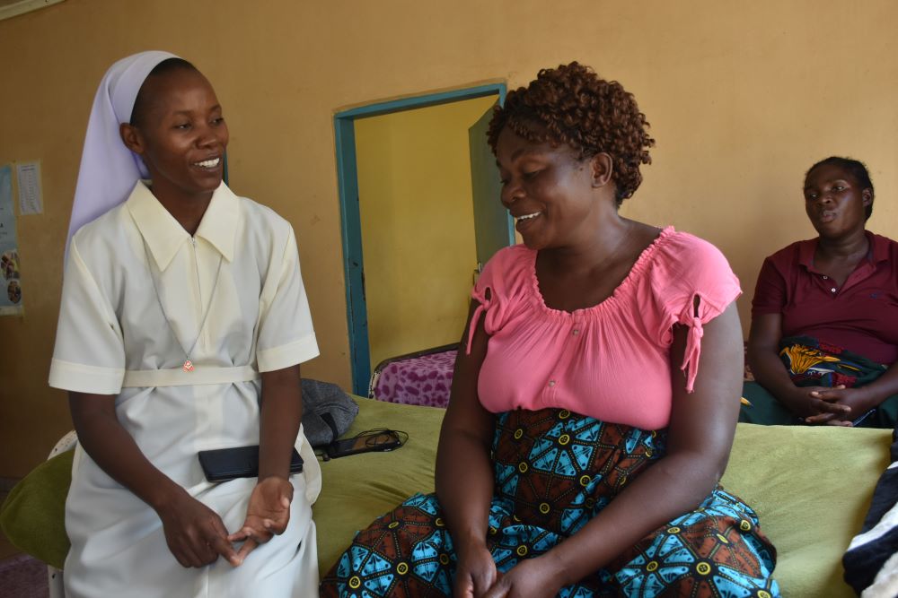 Holy Spirit Sr. Joyce Miyanda interacts with an expectant mother. Holy Spirit Sr. Joyce Miyanda interacts with an expectant mother.