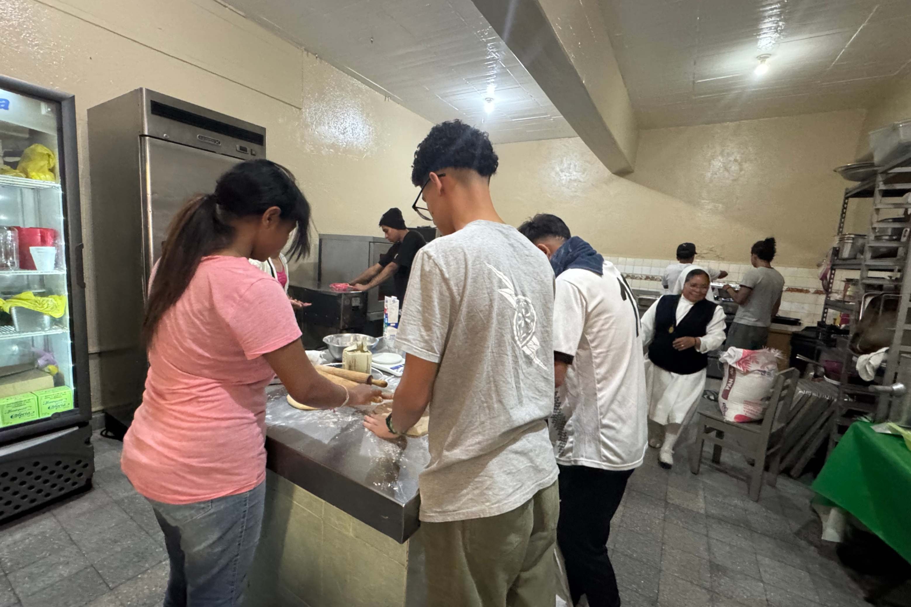 A group of young migrants bakes bread at the CAFEMIN shelter for women and families in Mexico City. (GSR photo/Rhina Guidos)