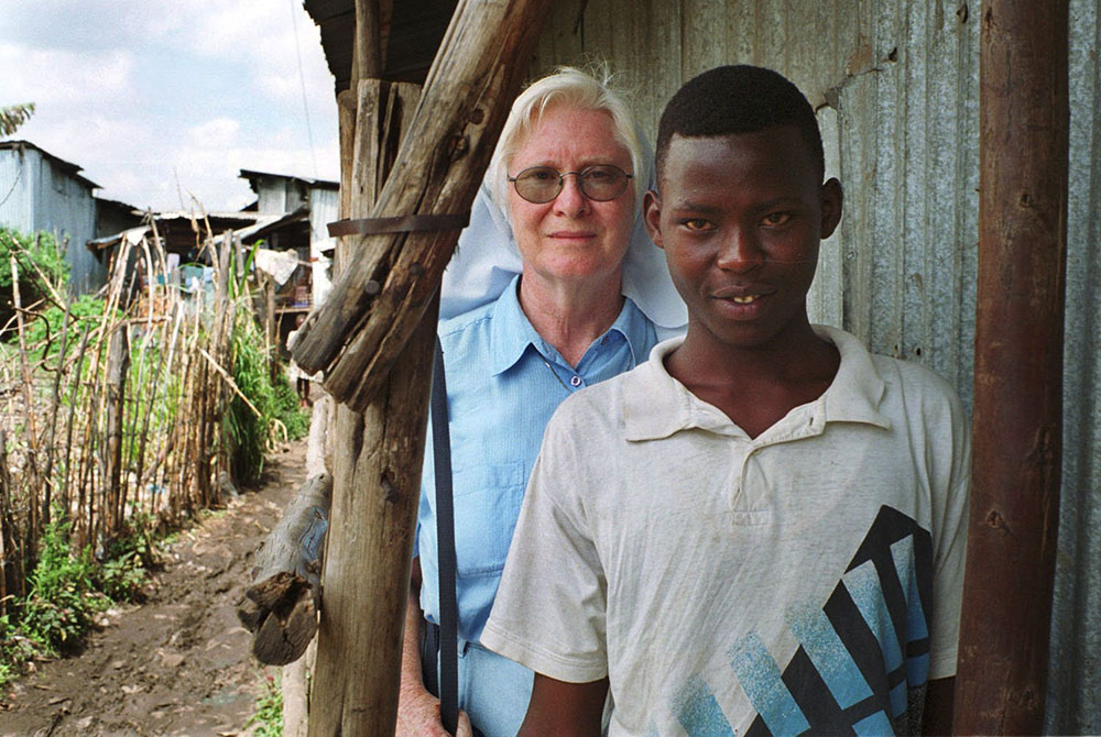 Mercy Sr. Mary Killeen from Ireland stands behind Benjamin Alenga Luvai, a former street boy and chairman of the Gap Centre for street boys in Nairobi, Kenya in this 2001 photo. (CNS/Declan Walsh)