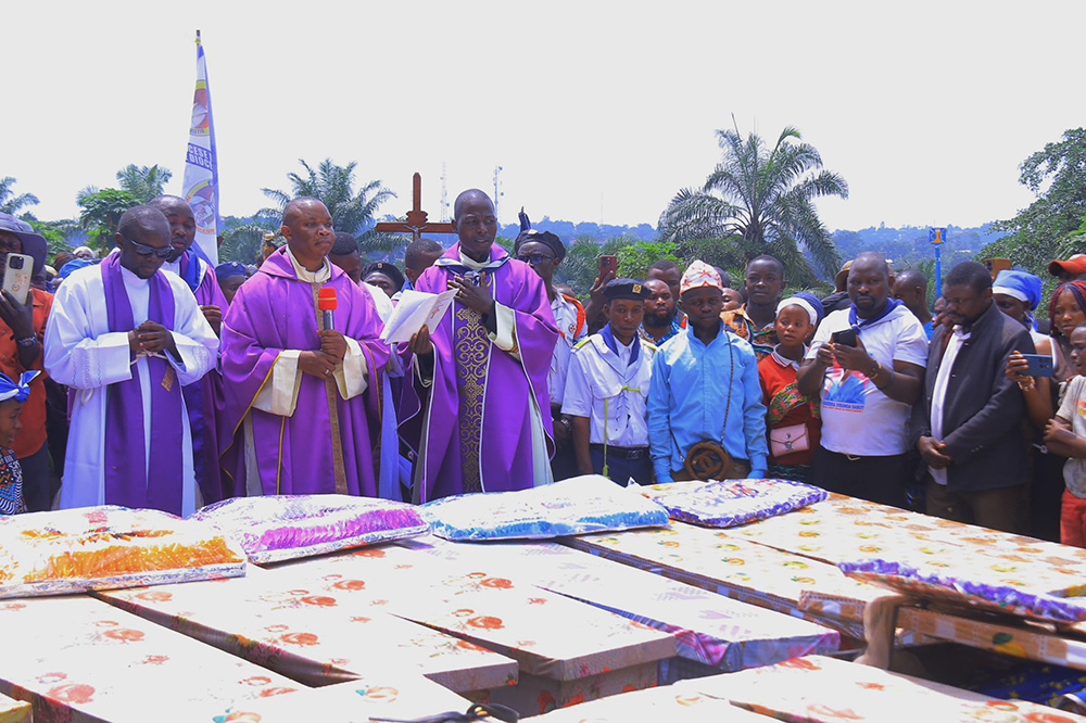 Fr. Aime Lokana Dhego, center, celebrates a funeral Mass in Komanda, in Congo's province of Ituri, July 28, for victims of a horrific attack on the Catholic church in Komanda, where at least 40 faithful were shot or killed with machetes during an overnight vigil in the church July 27. (OSV News/Courtesy of Fr. Justin Zanamuzi)