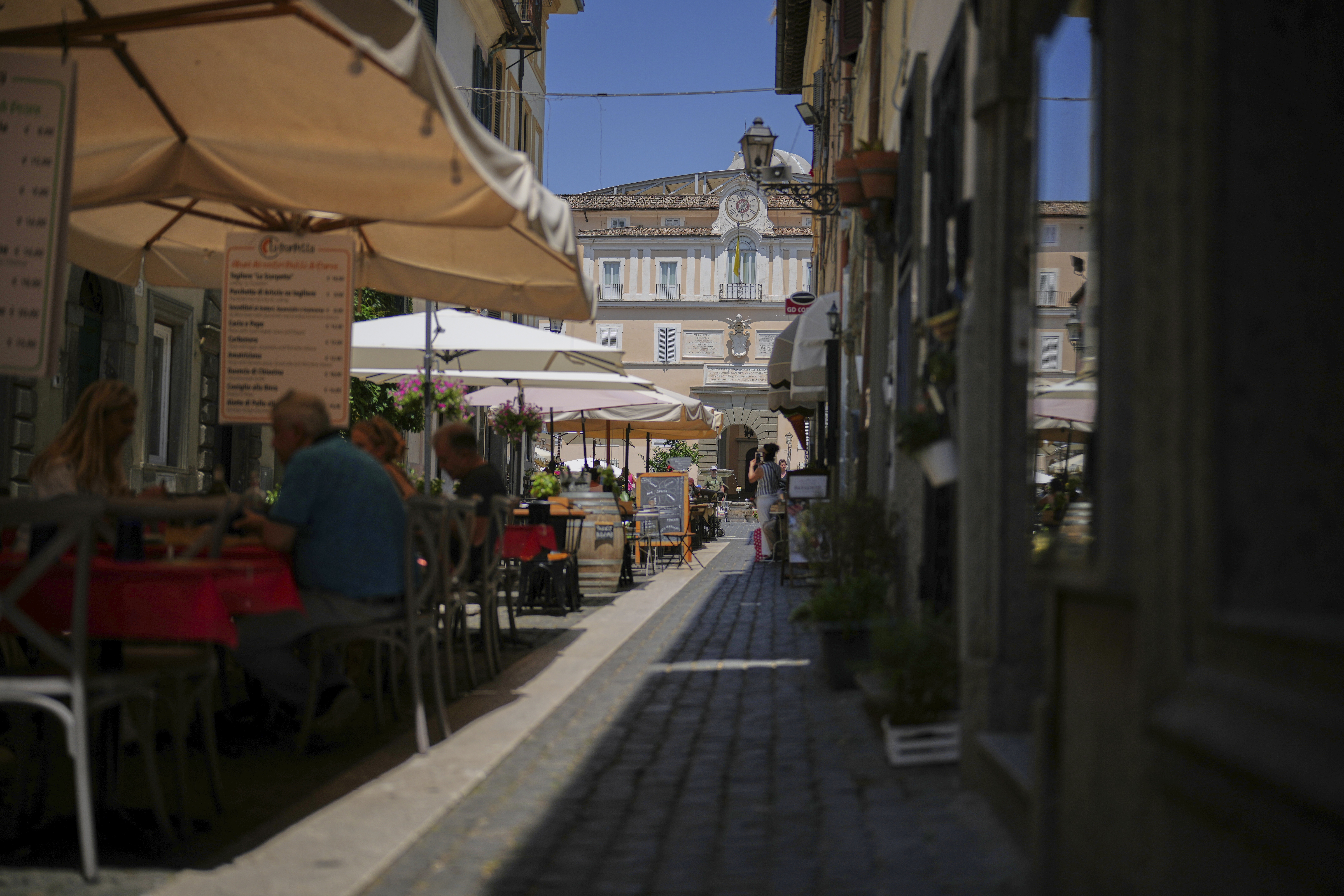 Customers have lunch at restaurants in the town of Castel Gandolfo, a historic summer retreat for popes about 30 kilometers southeast of Rome, where Pope Leo XIV will be spending a short period of rest, as seen Wednesday, July 2, 2025. (AP Photo/Andrew Medichini)