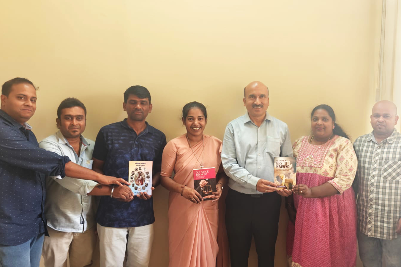 Sr. Lini Sheeja’s books, O Justice, Where Are You, Is There a GPS to Heaven? and Sound of Silence, Sr. Lini Sheeja (center in sari) with the publishing team behind her books.
