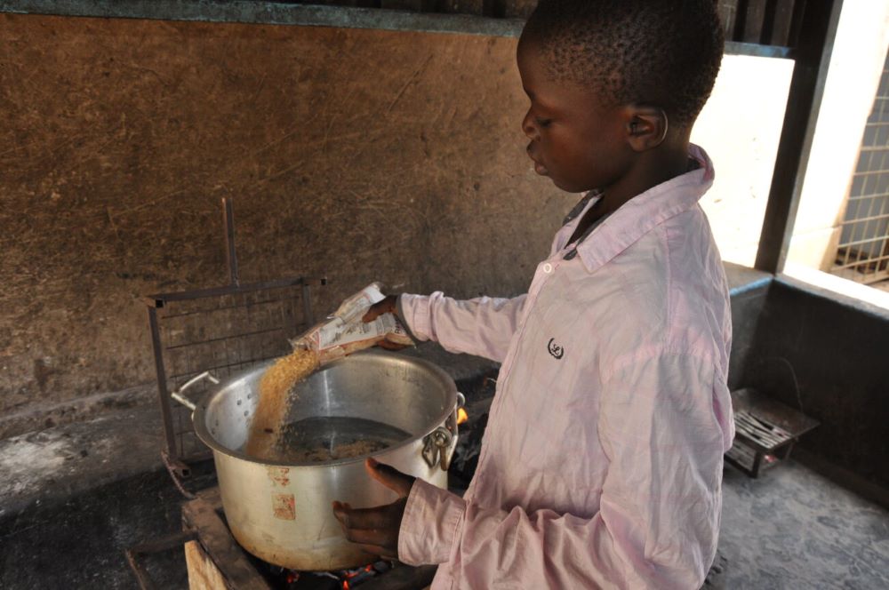 Boy with pot of rice Boy with pot of rice