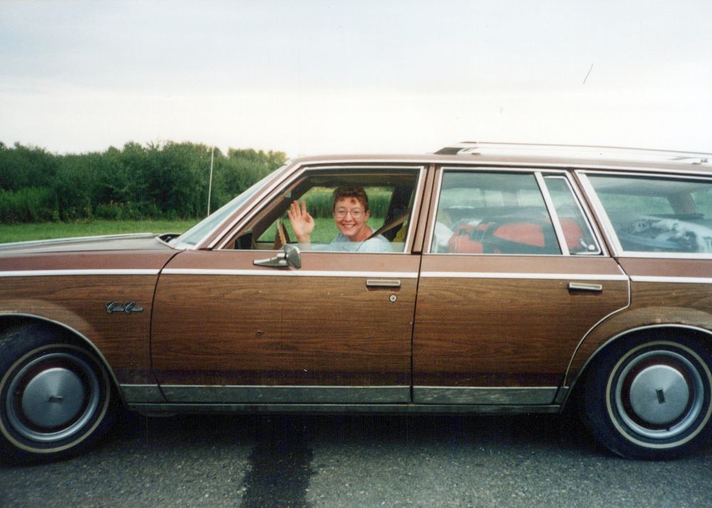 Sr. Vicky Larson driving station wagon Sr. Vicky Larson driving station wagon