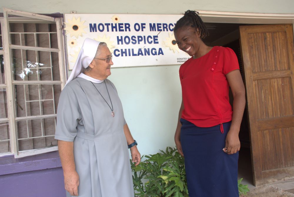 Sr. Jeremia Mrowiec and Esther Lungu talk outside hospice.  Sr. Jeremia Mrowiec and Esther Lungu talk outside hospice.
